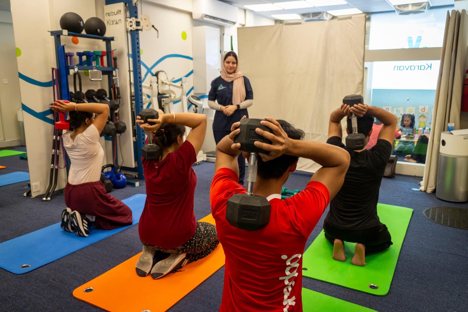 A coached group strength class training with dumbbells